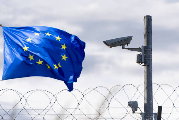European union flag and EU border with surveillance camera and barbed wire. Concept Picture under Unsplash-License.